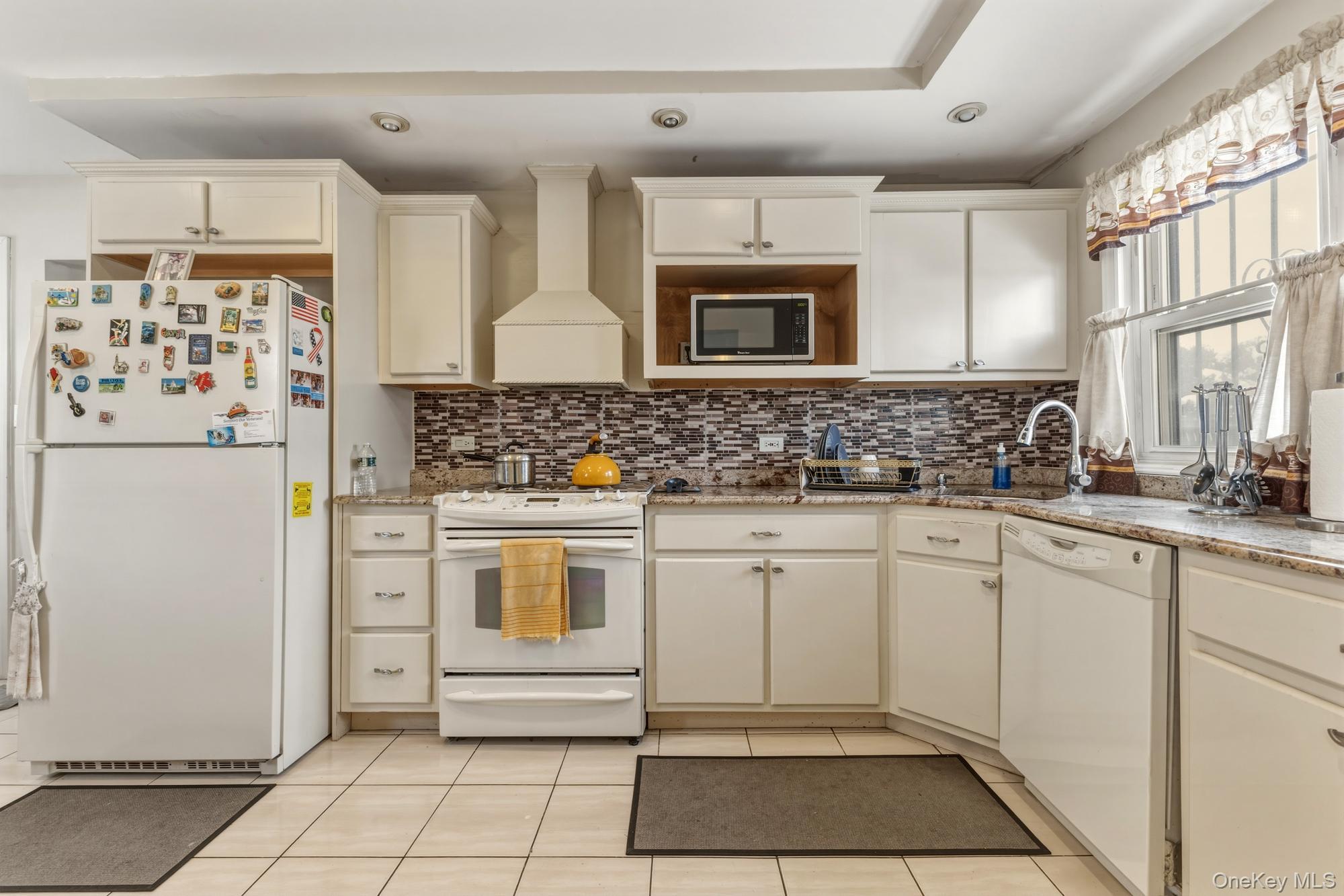 188-11 Dormans Road Queens, NY 11412 - Photo 8 of 32 a kitchen with stainless steel appliances a stove sink and refrigerator