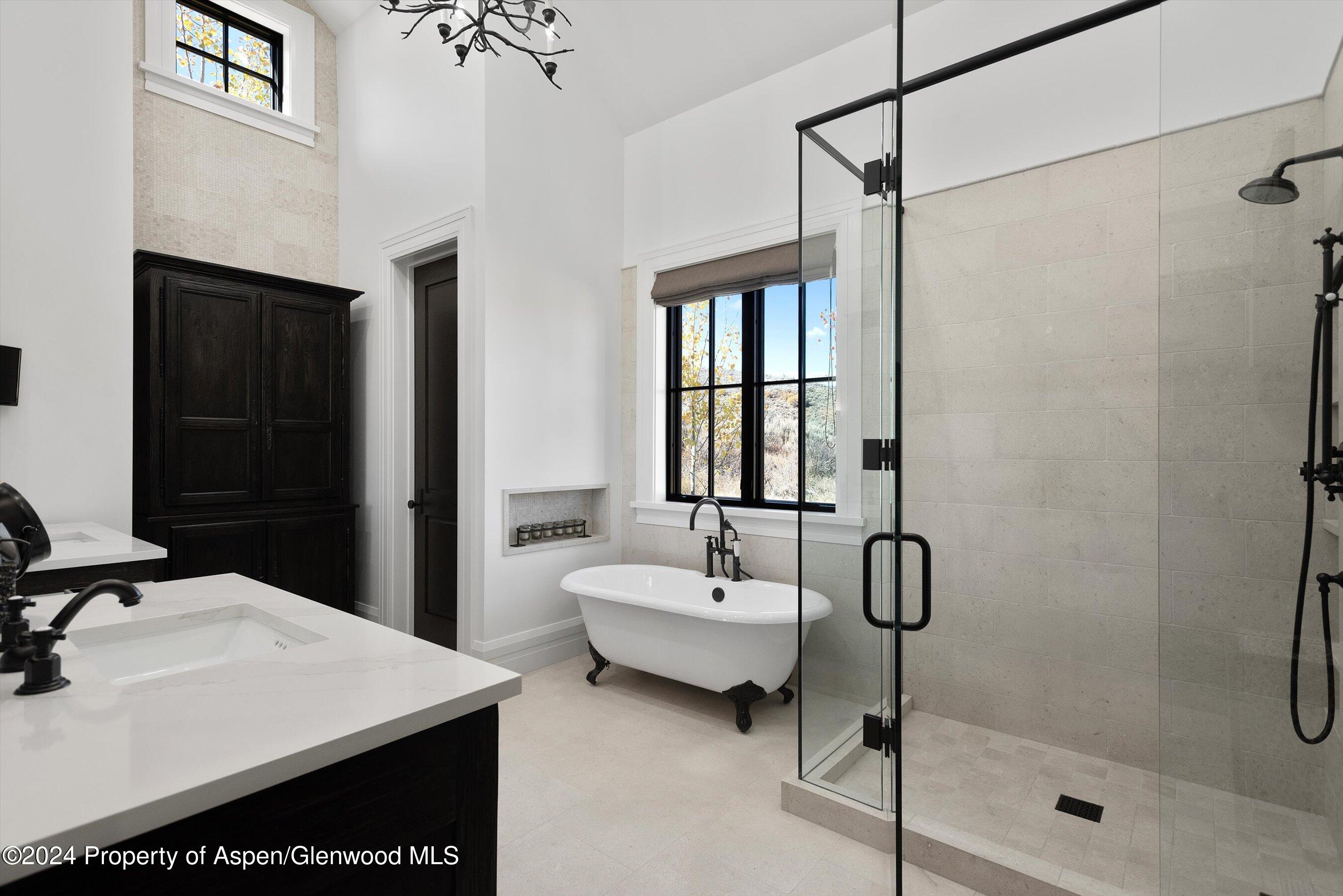 2388 Lazy O Road Snowmass, CO 81654 - Photo 26 of 65 a bathroom with a sink a window and a mirror