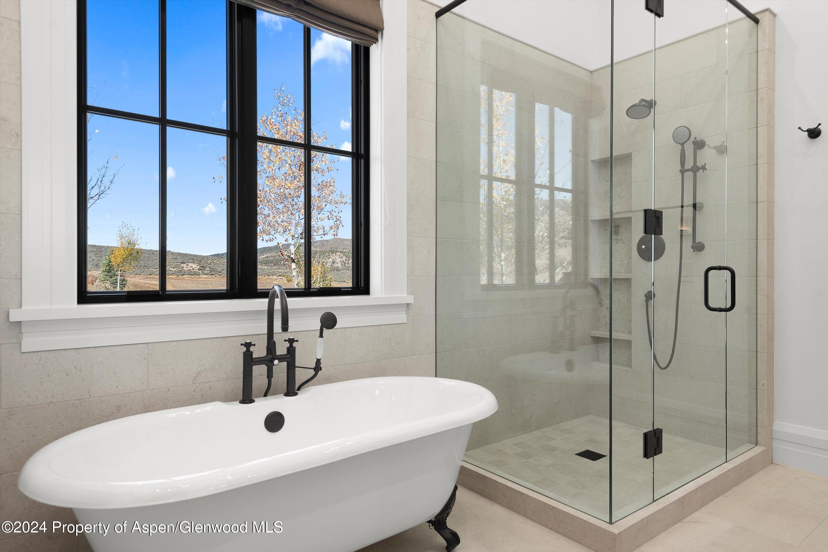 2388 Lazy O Road Snowmass, CO 81654 - Photo 27 of 65 a bathroom with a tub and a shower