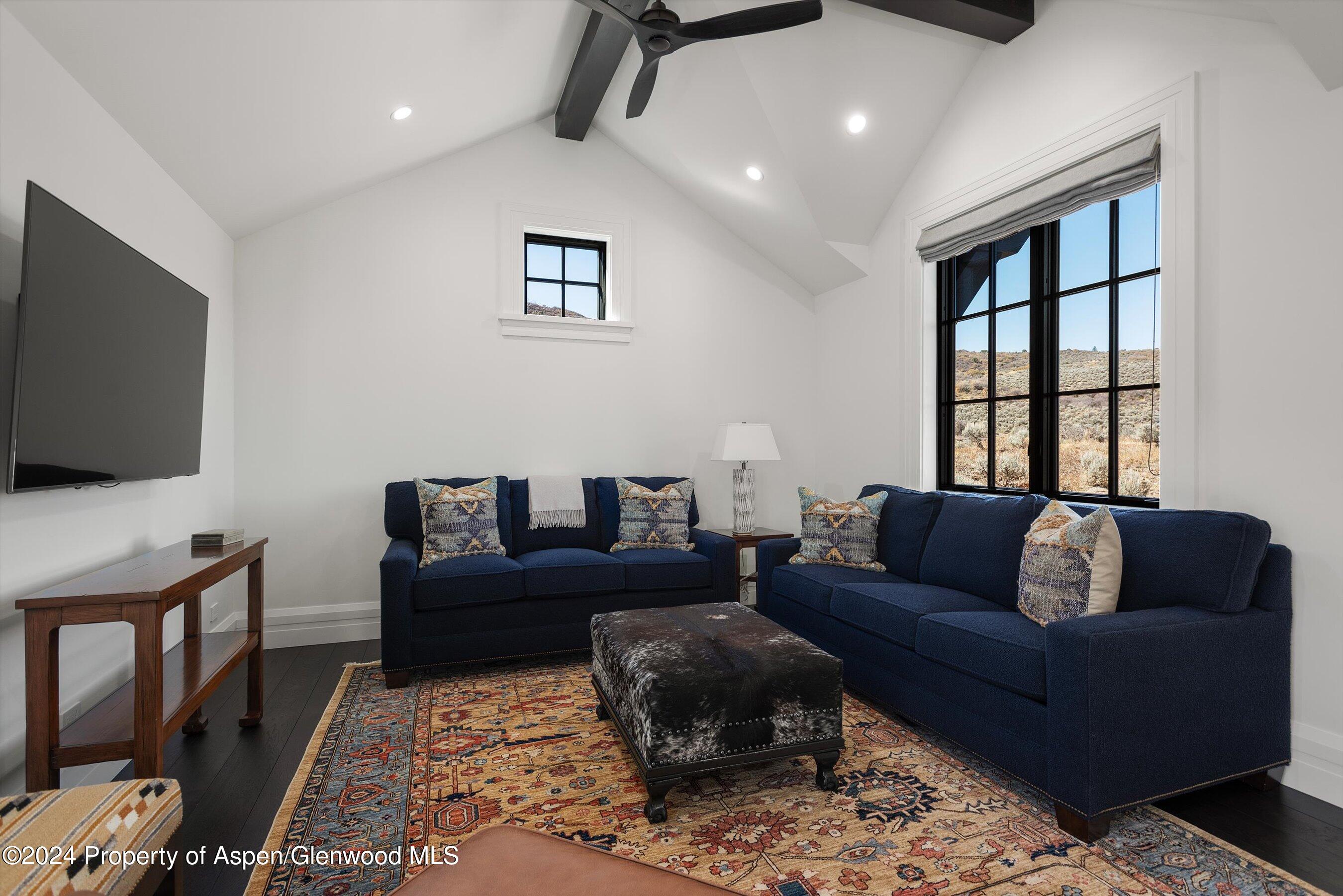 2388 Lazy O Road Snowmass, CO 81654 - Photo 31 of 65 a living room with furniture and a flat screen tv