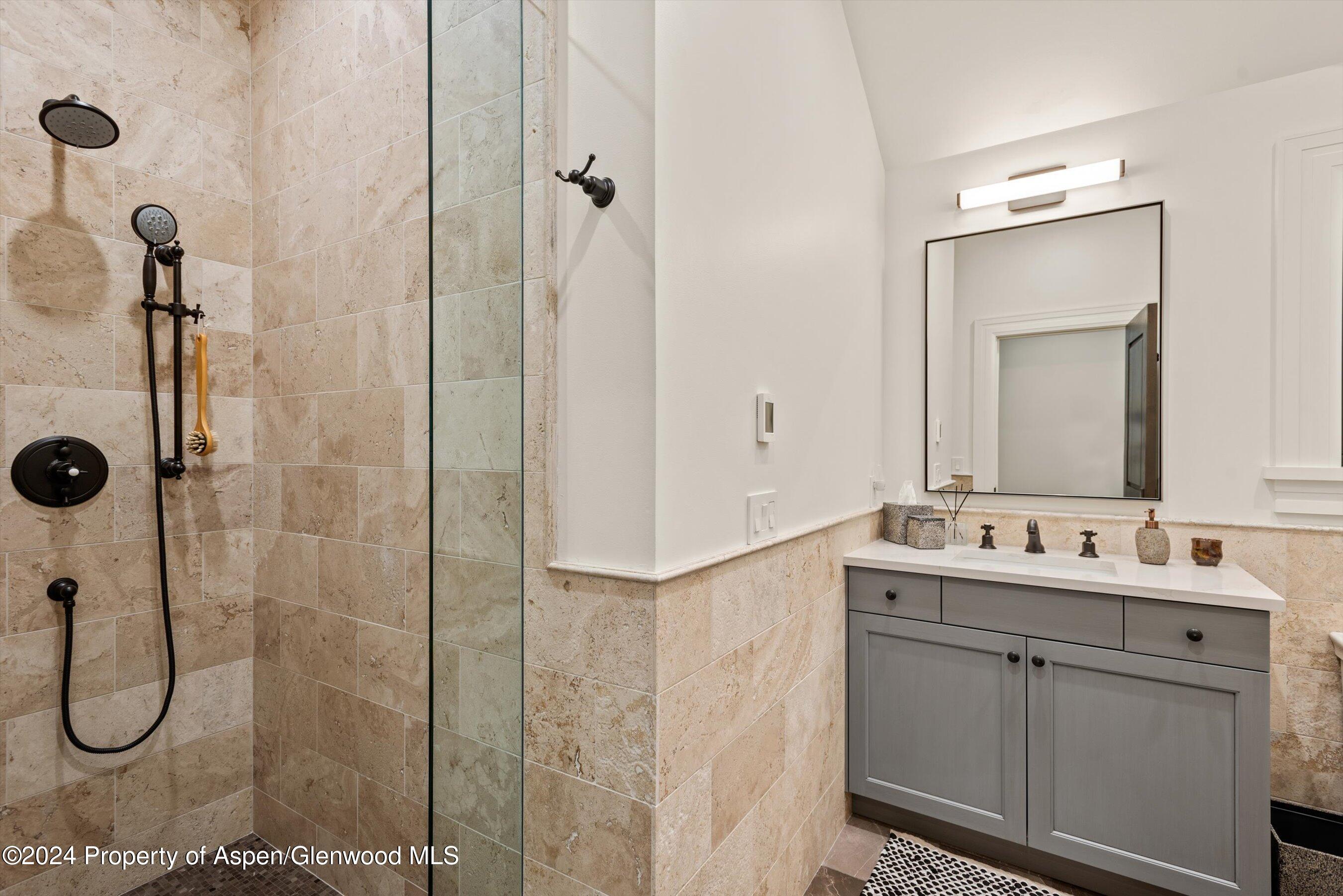 2388 Lazy O Road Snowmass, CO 81654 - Photo 36 of 65 a bathroom with a double vanity sink mirror and shower