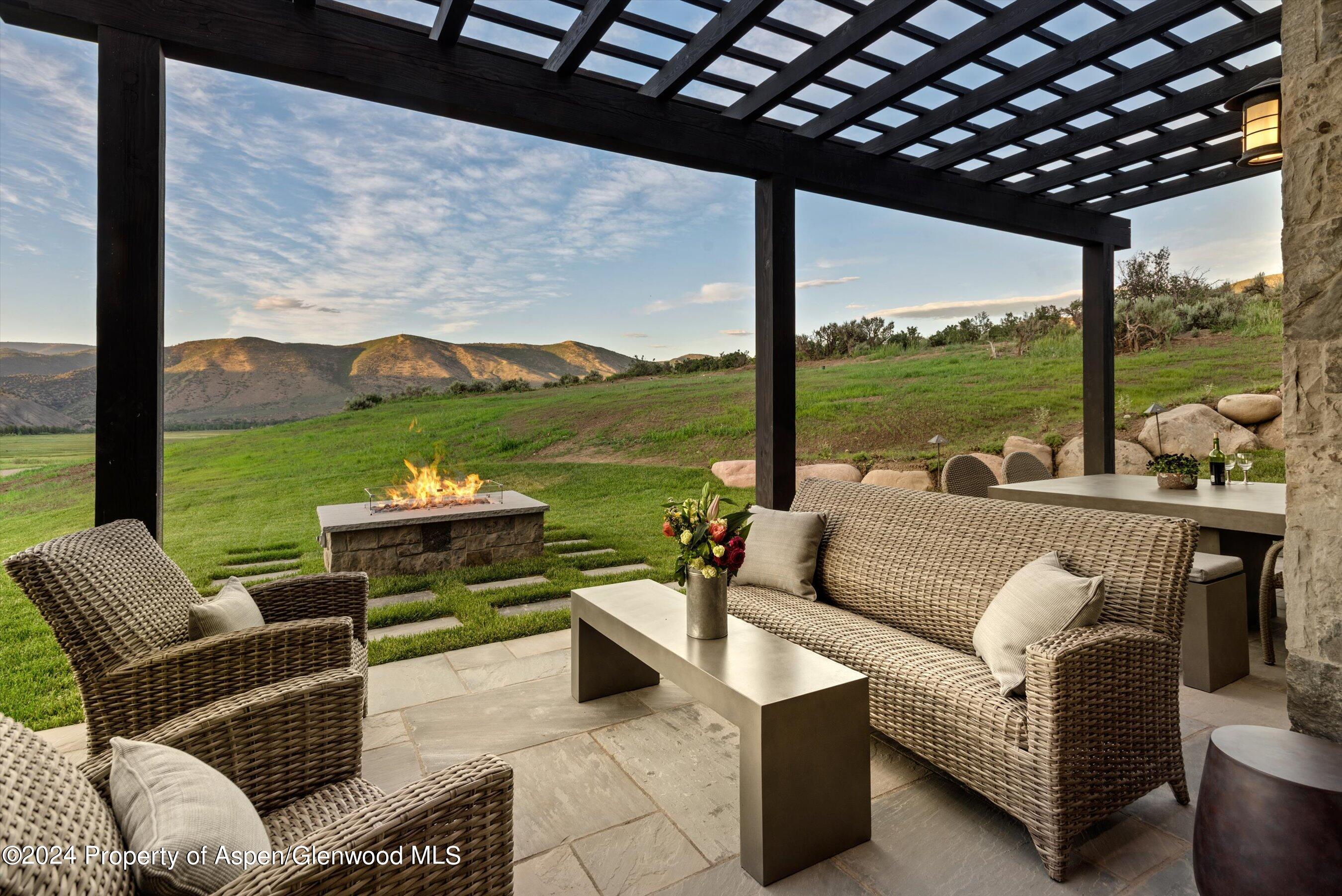2388 Lazy O Road Snowmass, CO 81654 - Photo 4 of 65 a view of a patio with couches potted plants and ocean view