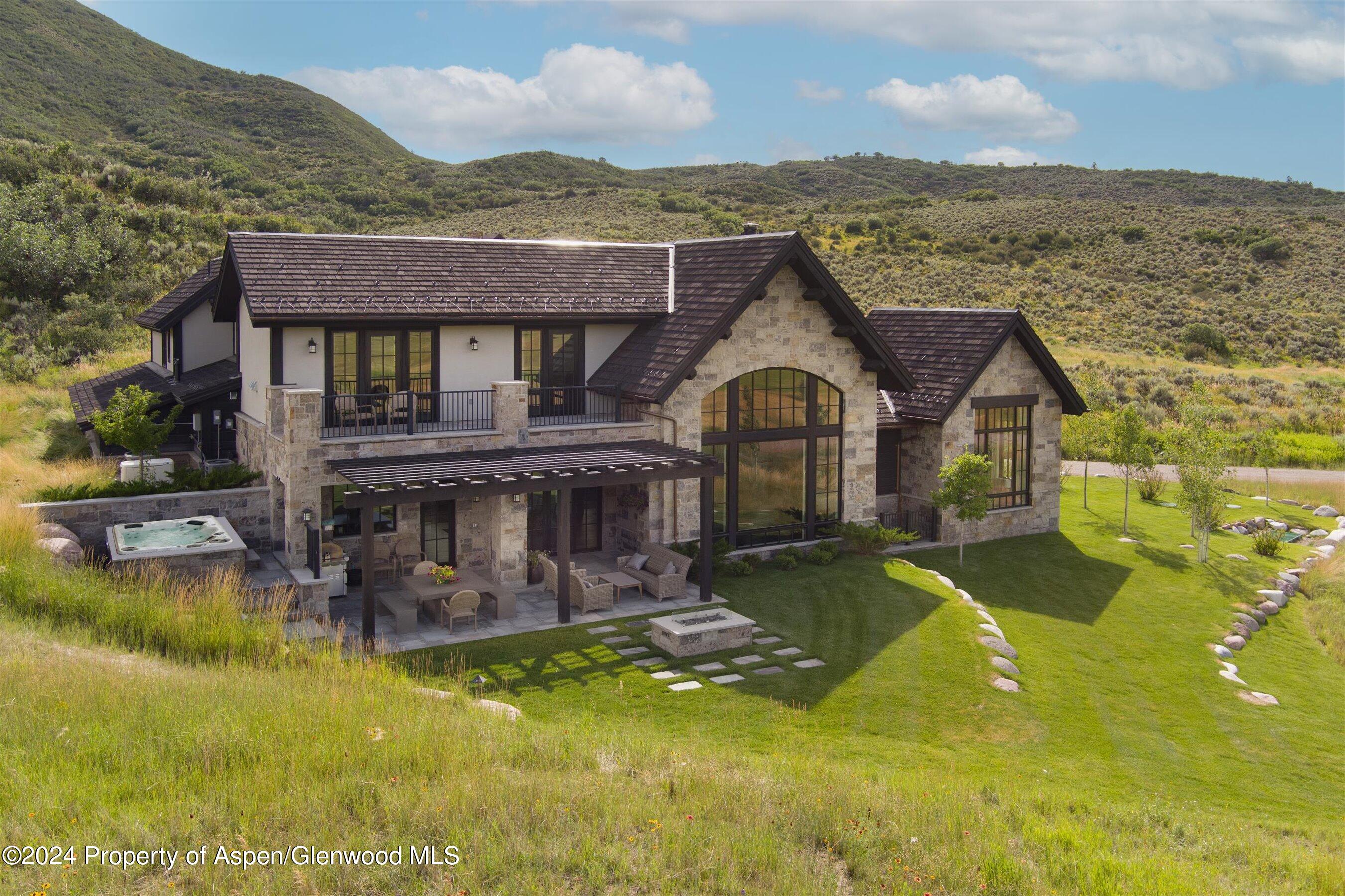2388 Lazy O Road Snowmass, CO 81654 - Photo 46 of 65 an aerial view of a house with swimming pool and mountains