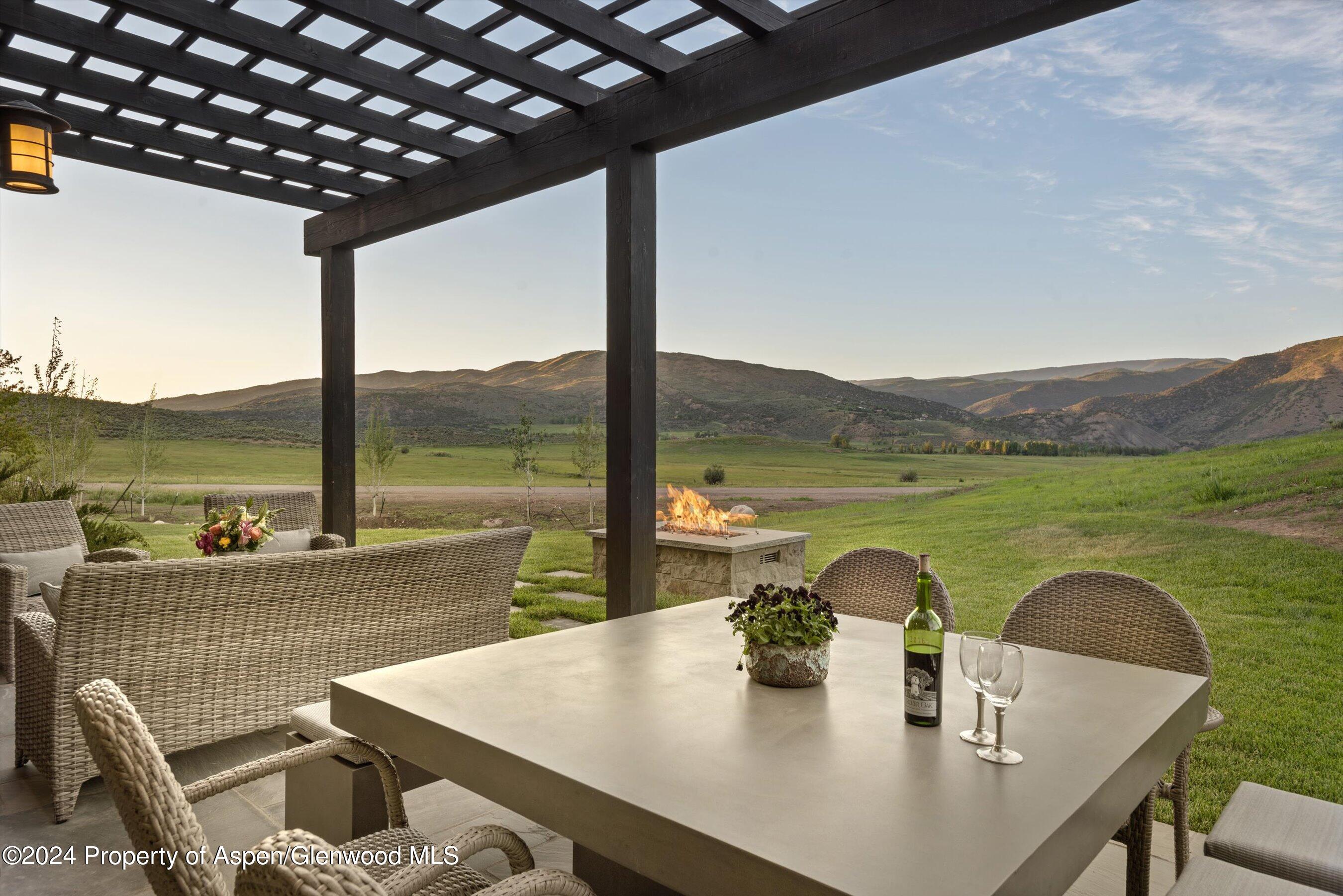 2388 Lazy O Road Snowmass, CO 81654 - Photo 6 of 65 a view of an outdoor dining space with a table and chairs