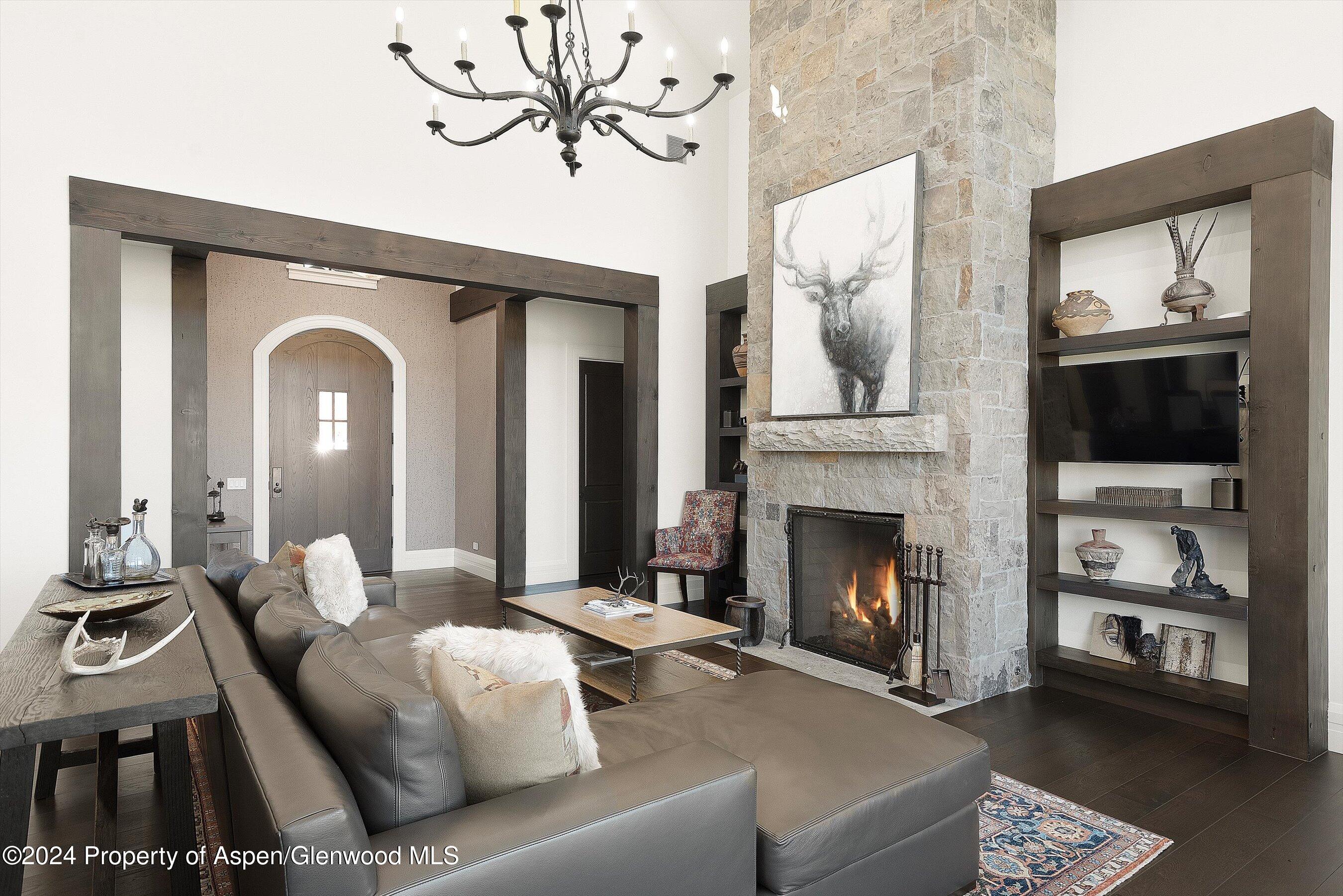 2388 Lazy O Road Snowmass, CO 81654 - Photo 9 of 65 a living room with furniture a fireplace and a flat screen tv