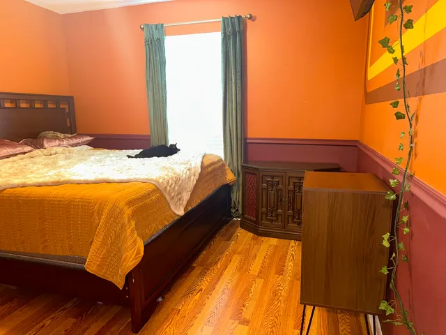 a bed sitting in a bedroom next to a window