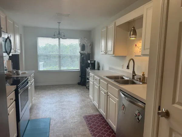 a kitchen with a sink stove and cabinets