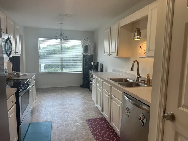 a kitchen with a sink stove and cabinets