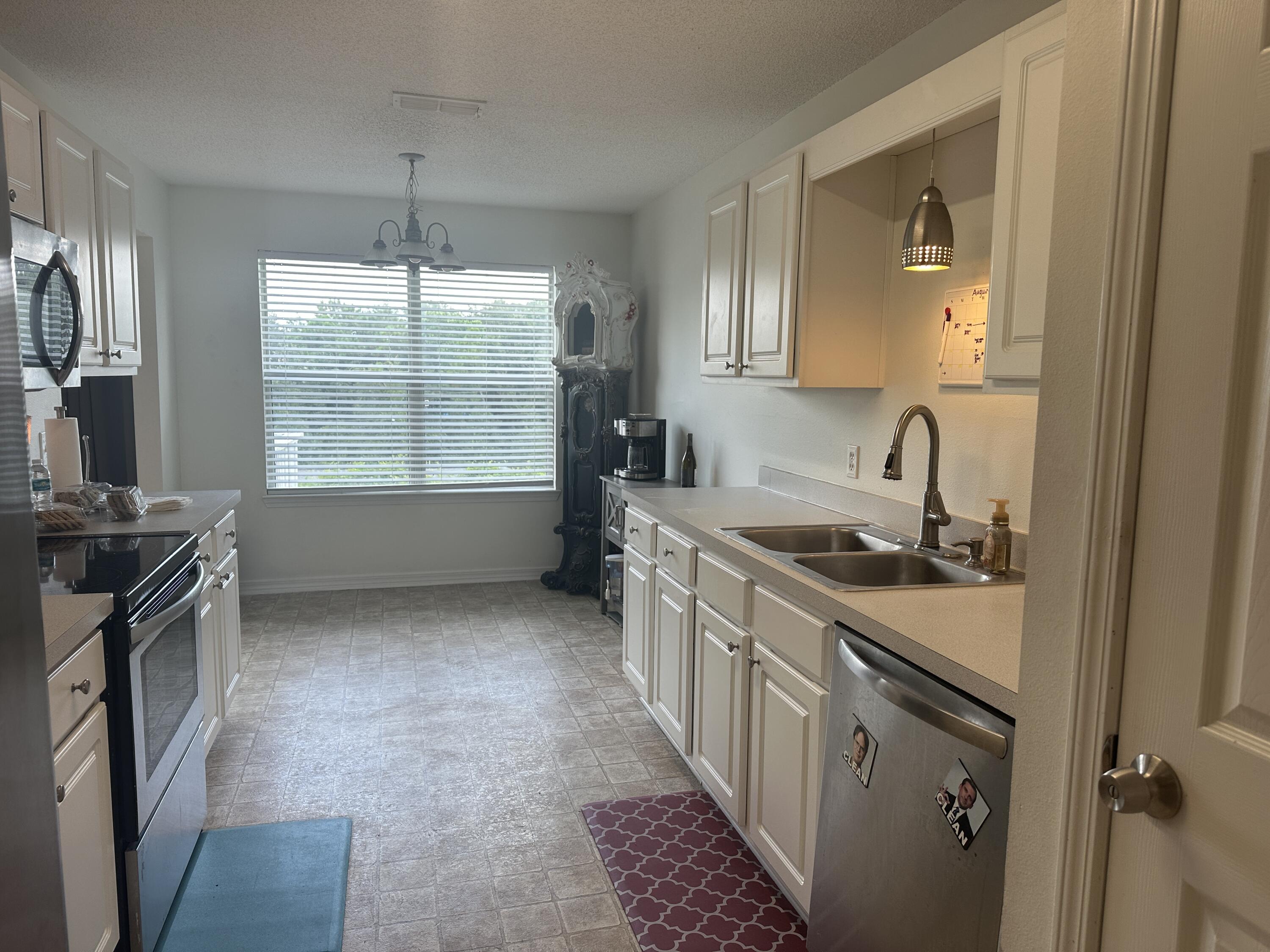 228 Trish Drive Crestview, FL 32536 - Photo 13 of 34 a kitchen with a sink stove and cabinets