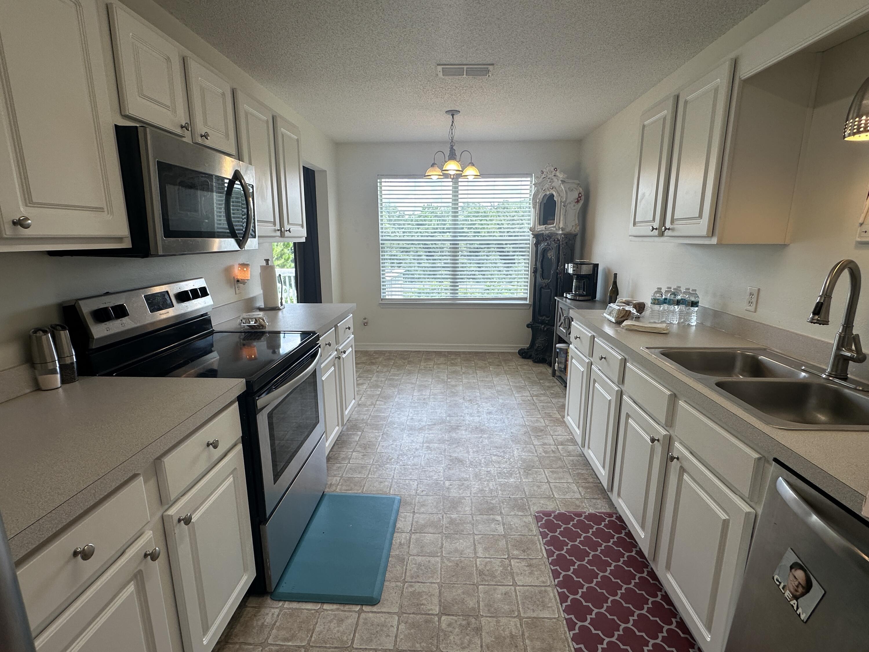 228 Trish Drive Crestview, FL 32536 - Photo 14 of 34 a kitchen with stainless steel appliances a sink stove microwave and refrigerator