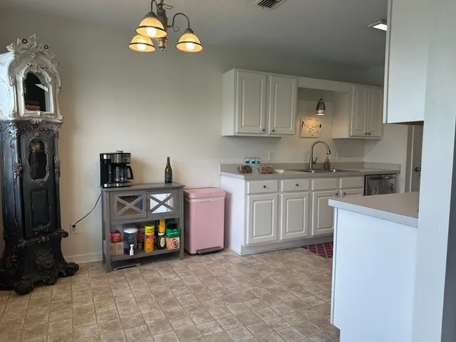 a kitchen that has a lot of cabinets in it