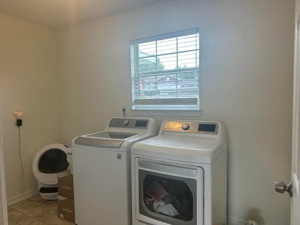 a view of a storage and utility room with a washer and dryer