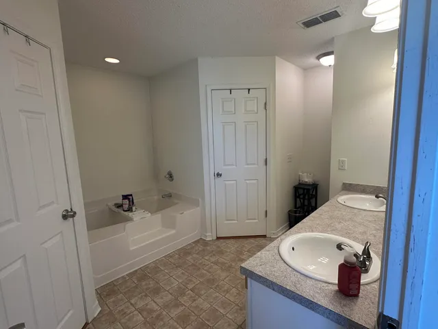 a bathroom with a tub and shower