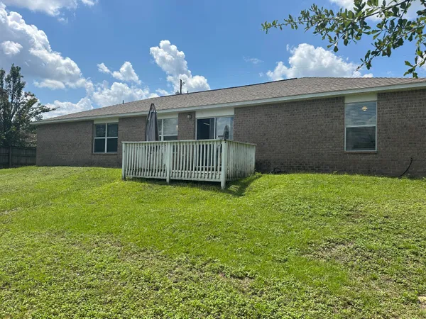 a view of a house with a back yard