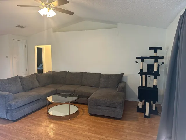 a living room with furniture a chandelier and a window