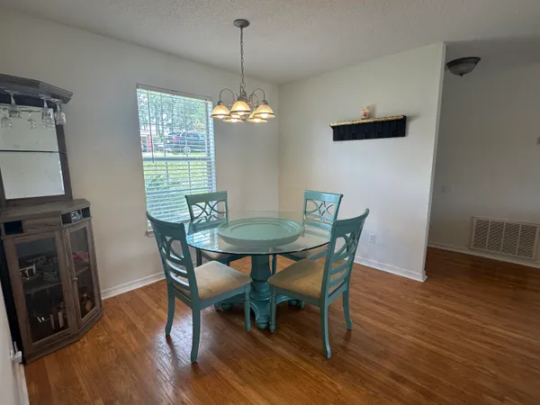 a view of a dining room with furniture window and wooden floor