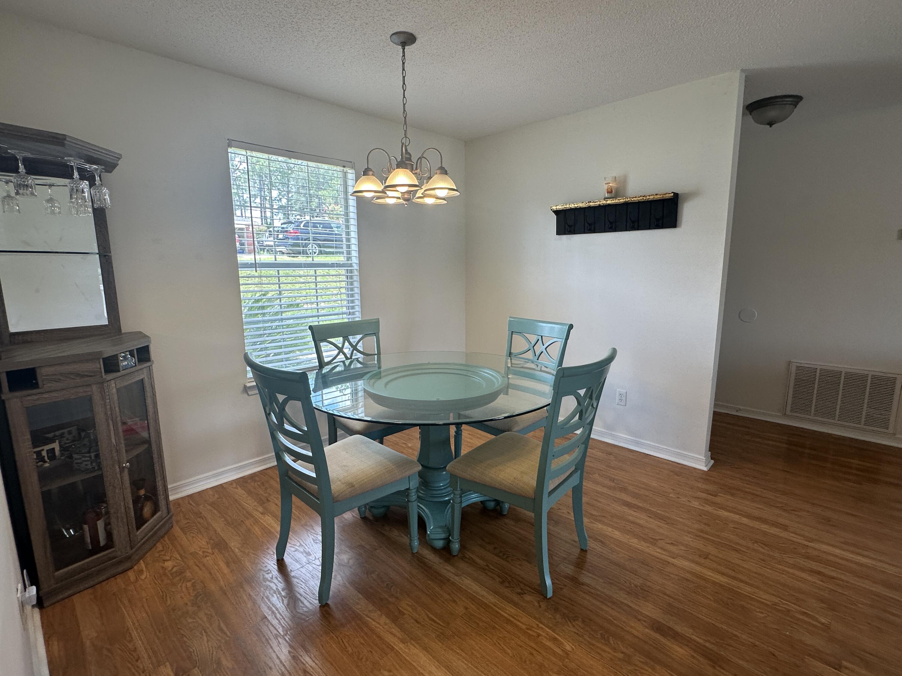228 Trish Drive Crestview, FL 32536 - Photo 7 of 34 a view of a dining room with furniture window and wooden floor
