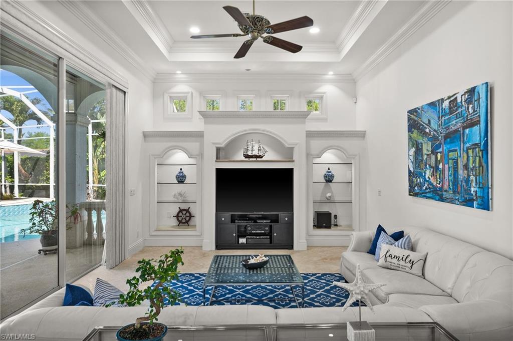 6898 Mill Run Road Naples, FL 34109 - Photo 11 of 38 a living room with furniture and a fireplace