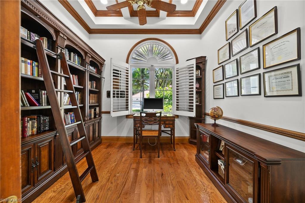6898 Mill Run Road Naples, FL 34109 - Photo 14 of 38 a living room with furniture and a wooden floor