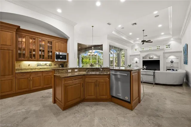 a large kitchen with stainless steel appliances kitchen island granite countertop a stove and a sink