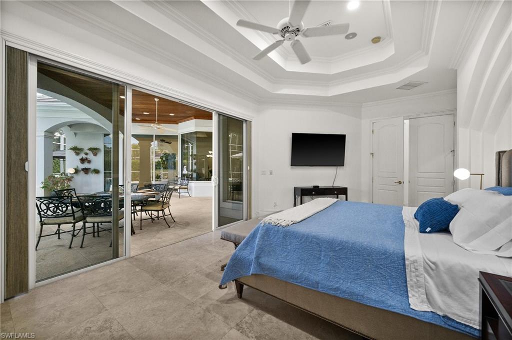 6898 Mill Run Road Naples, FL 34109 - Photo 17 of 38 a bedroom with a bed and large windows