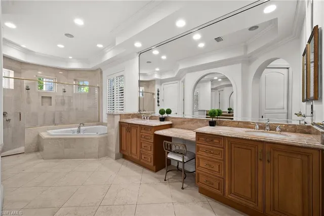 a large bathroom with a granite countertop double vanity sink a toilet a bathtub and shower