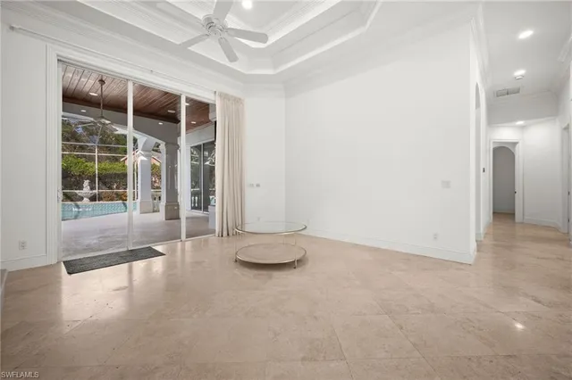 an empty room with floor to ceiling window and an outdoor space