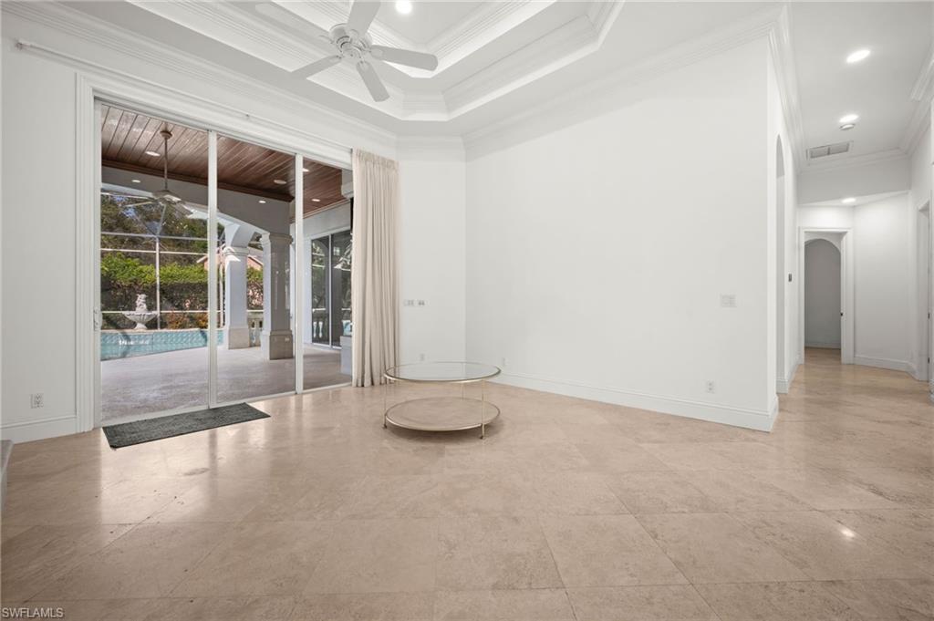 6898 Mill Run Road Naples, FL 34109 - Photo 28 of 38 an empty room with floor to ceiling window and an outdoor space