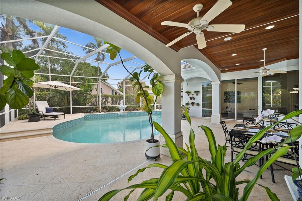 6898 Mill Run Road Naples, FL 34109 - Photo 30 of 38 a view of a patio with table and chairs potted plants