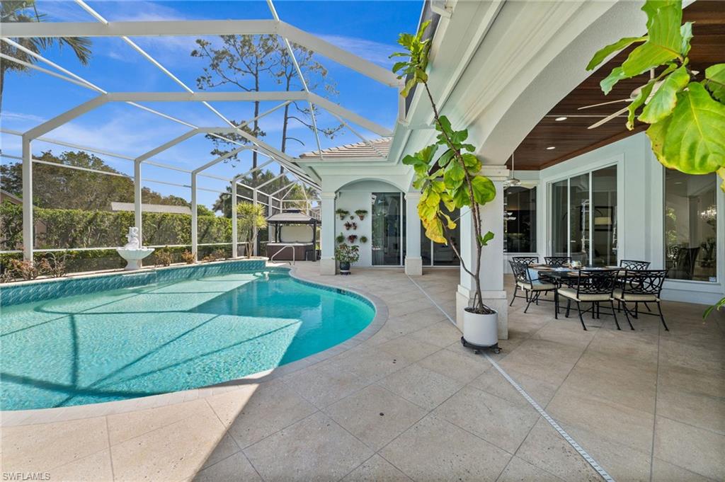 6898 Mill Run Road Naples, FL 34109 - Photo 32 of 38 a view of a chairs and table in the patio