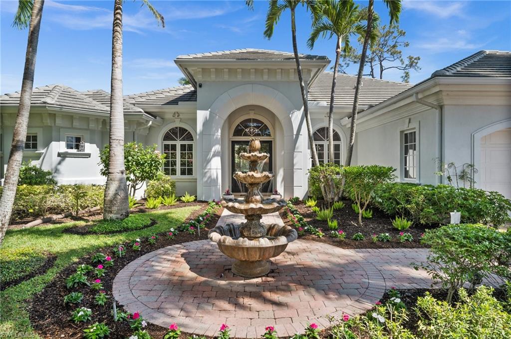 6898 Mill Run Road Naples, FL 34109 - Photo 4 of 38 a front view of a house with a garden