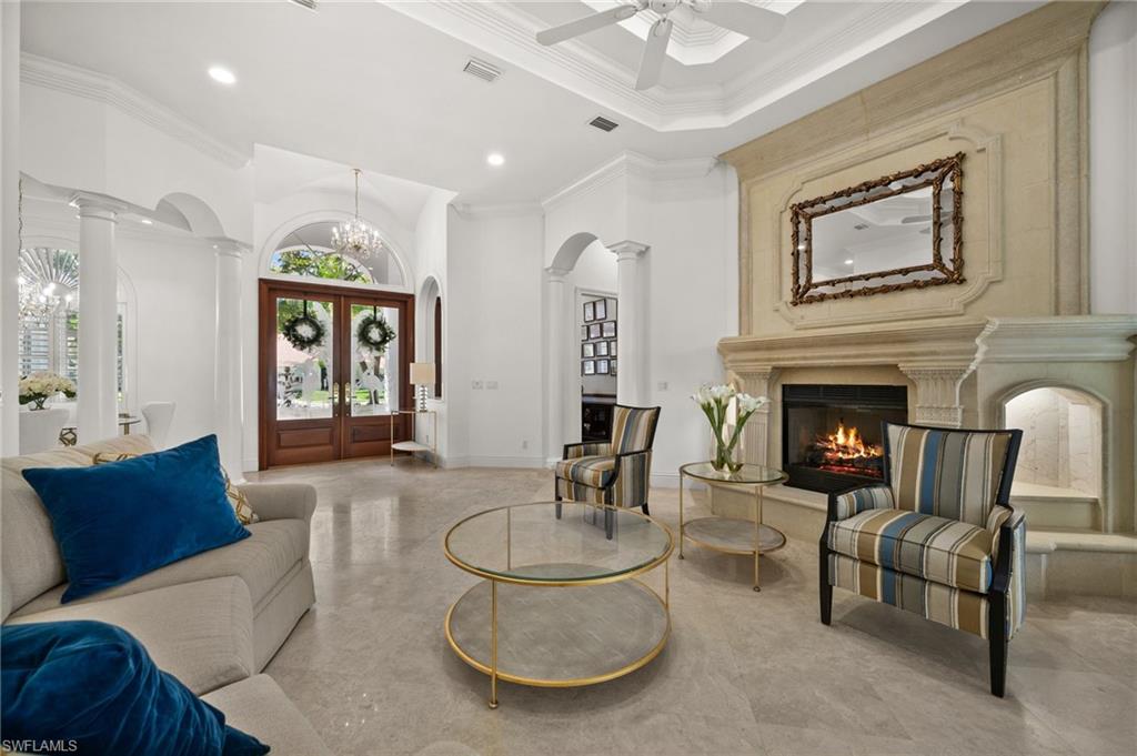 6898 Mill Run Road Naples, FL 34109 - Photo 9 of 38 a living room with furniture and a fireplace