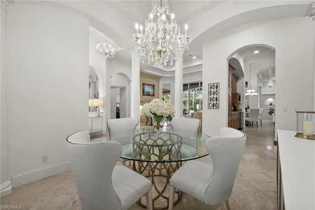 a living room with fireplace furniture and a chandelier