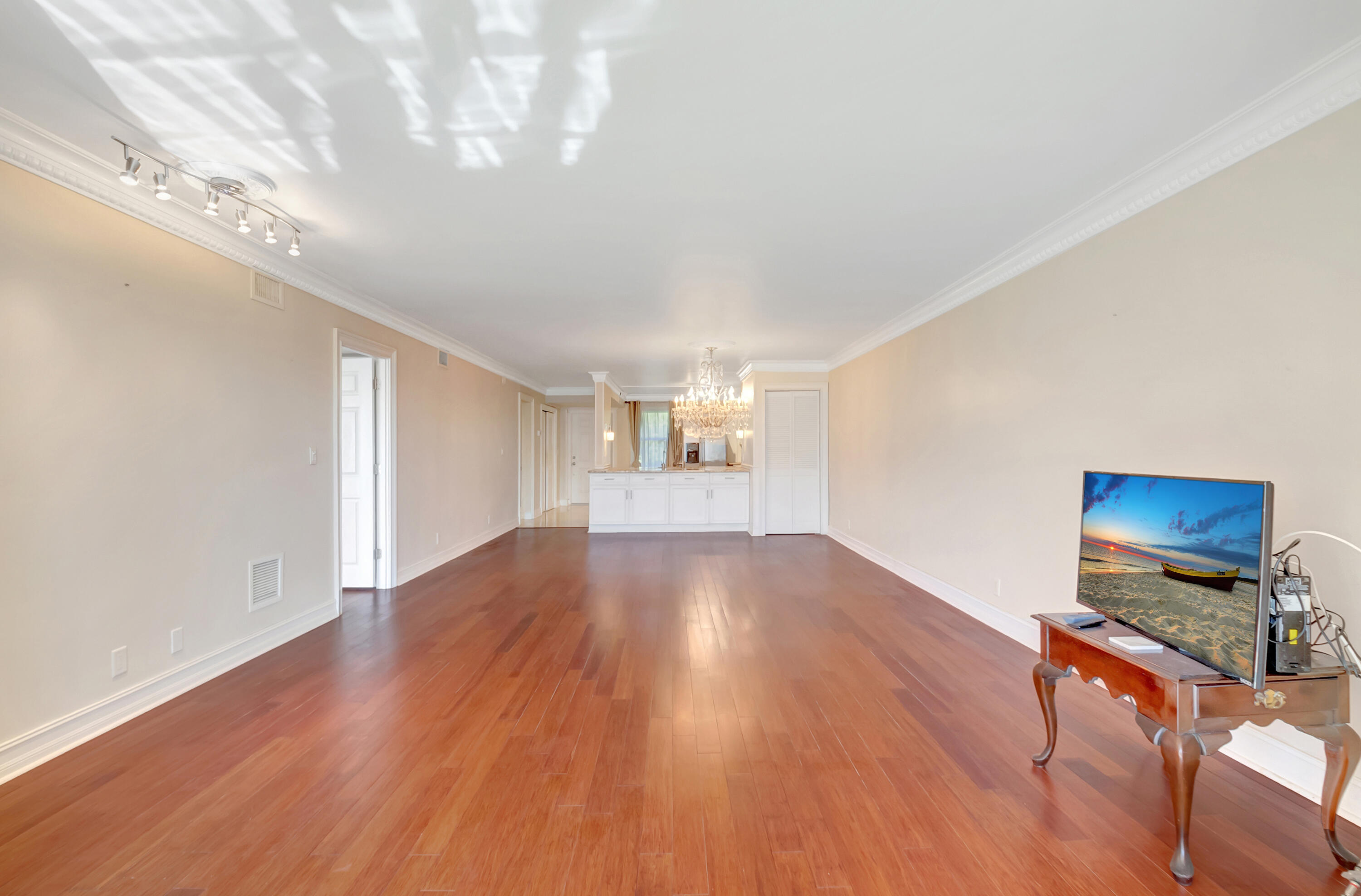 2871 North Ocean Boulevard, Unit C205 Boca Raton, FL 33431 - Photo 13 of 97 a view of an empty room with wooden floor and a window