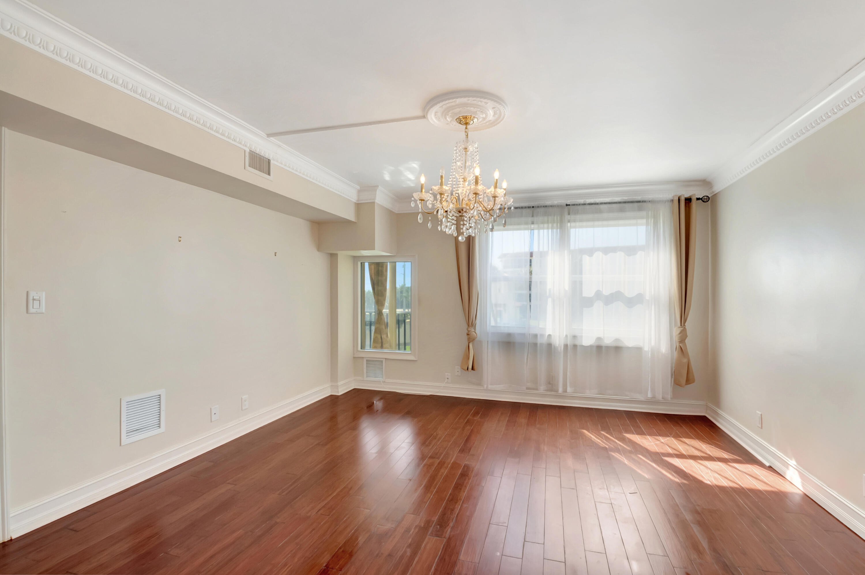 2871 North Ocean Boulevard, Unit C205 Boca Raton, FL 33431 - Photo 17 of 97 a view of a room with wooden floor and large windows