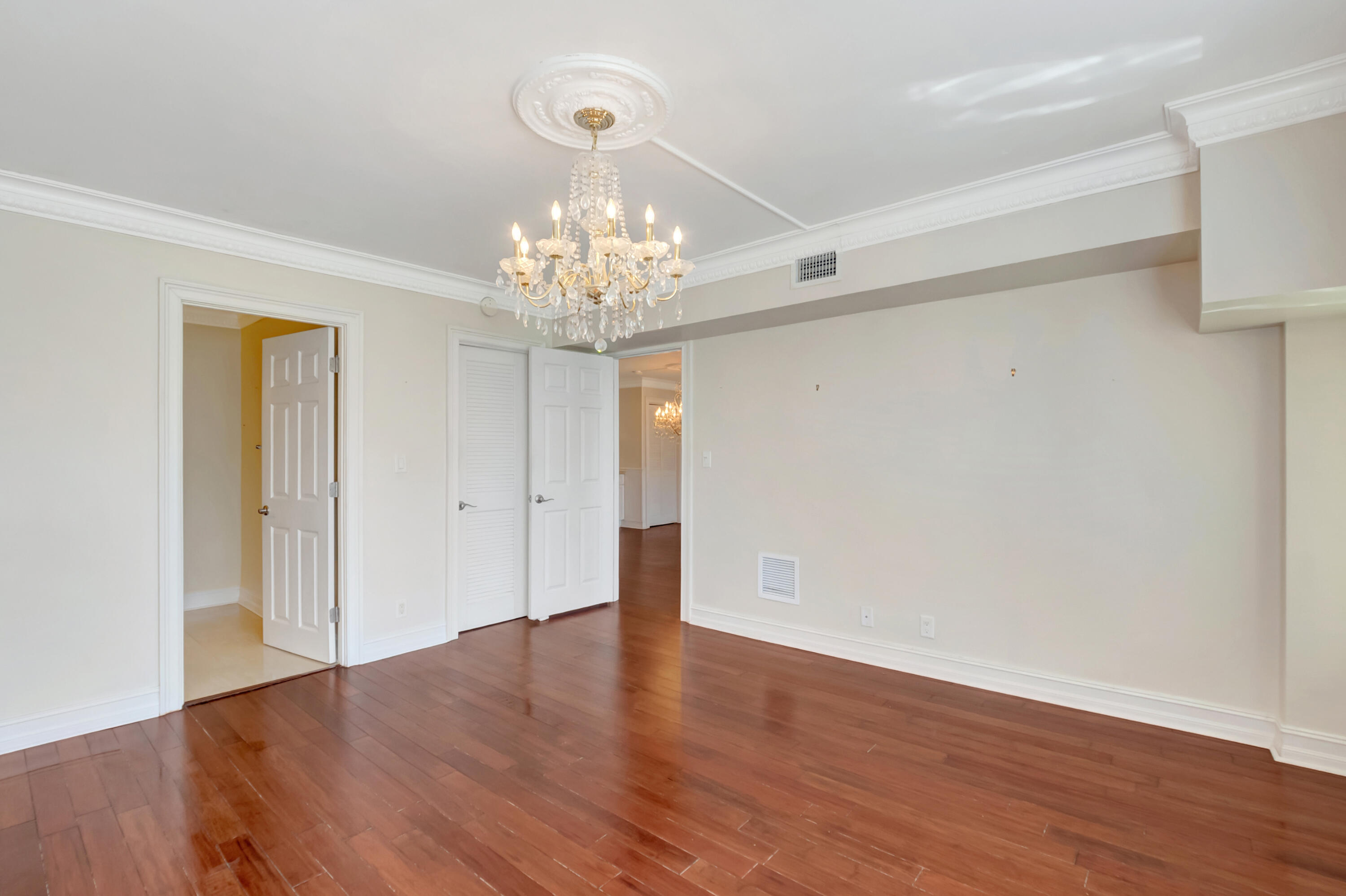 2871 North Ocean Boulevard, Unit C205 Boca Raton, FL 33431 - Photo 18 of 97 a view of an empty room with wooden floor