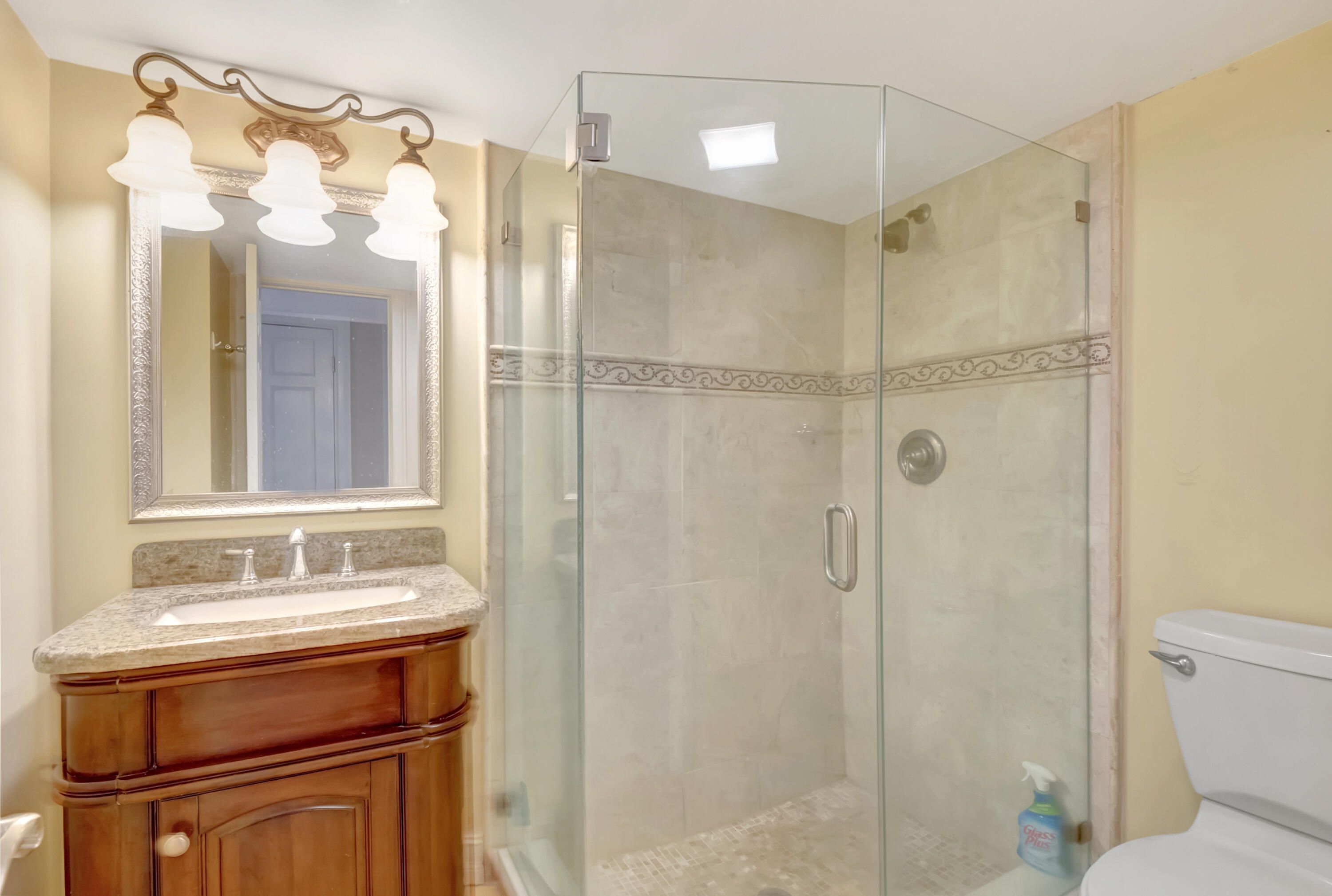 2871 North Ocean Boulevard, Unit C205 Boca Raton, FL 33431 - Photo 27 of 97 a bathroom with a sink a toilet and shower