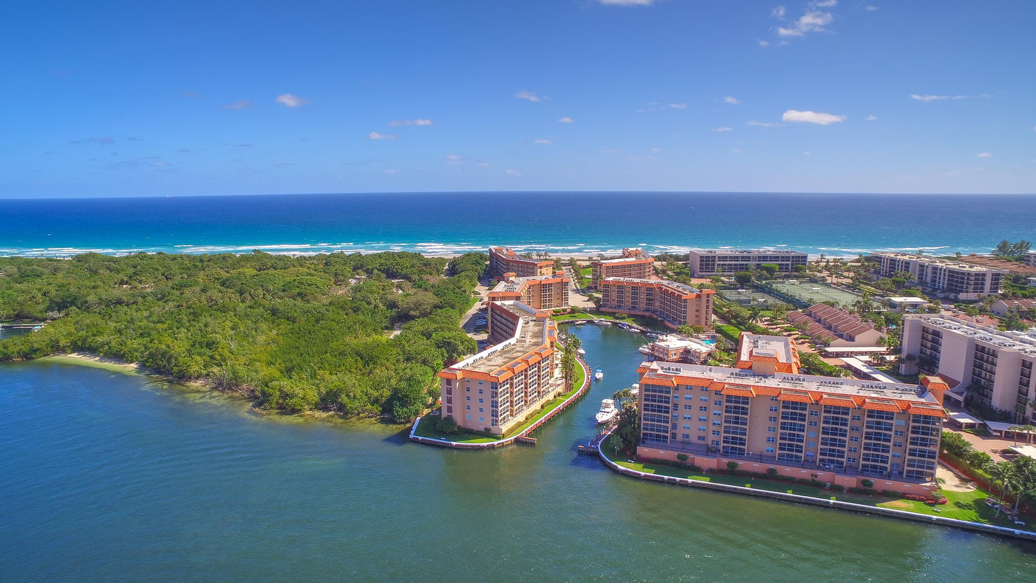 2871 North Ocean Boulevard, Unit C205 Boca Raton, FL 33431 - Photo 36 of 97 an aerial view of a city with lots of residential buildings ocean and mountain view in back