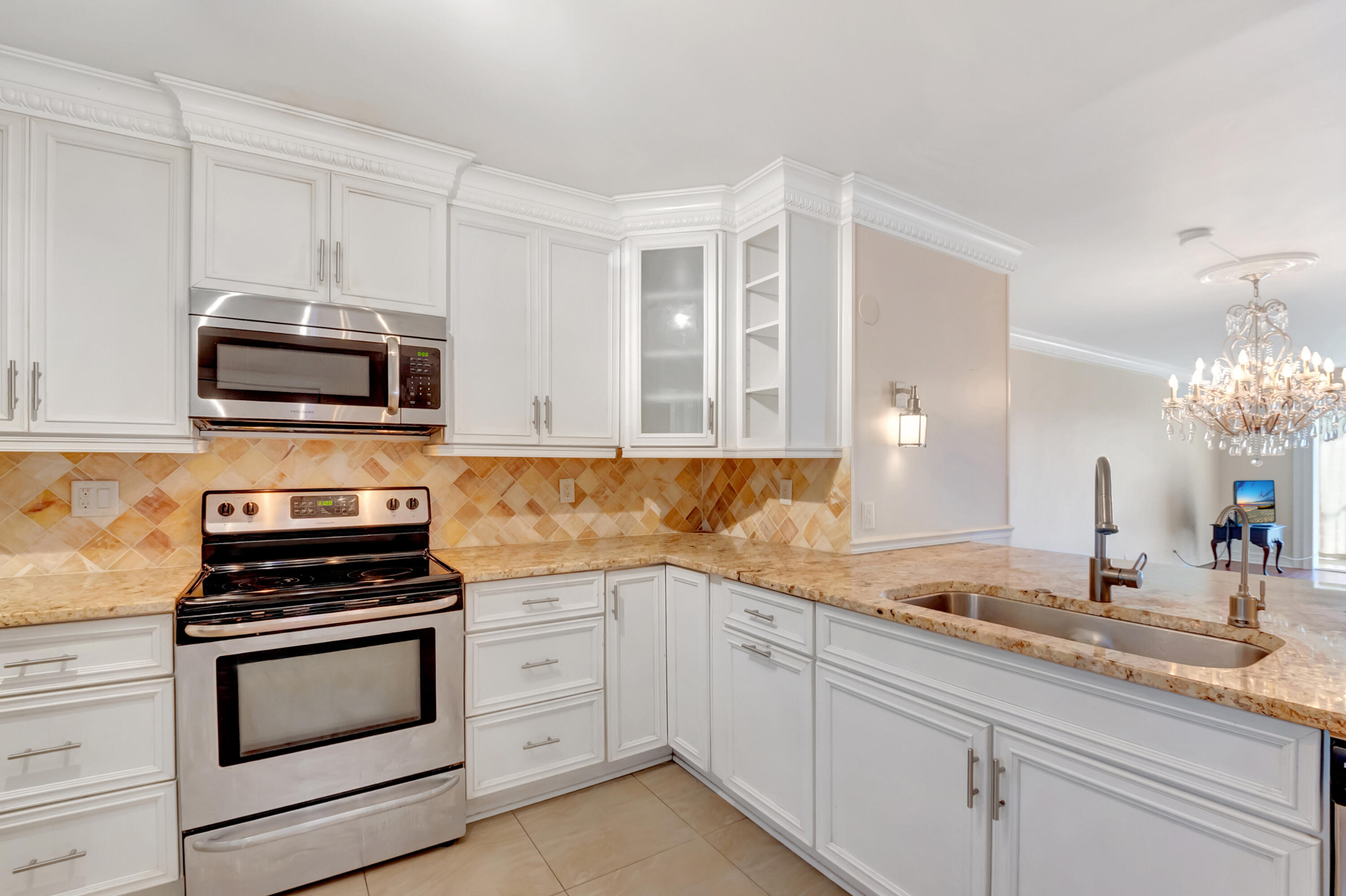 2871 North Ocean Boulevard, Unit C205 Boca Raton, FL 33431 - Photo 4 of 97 a kitchen with granite countertop a stove and a sink