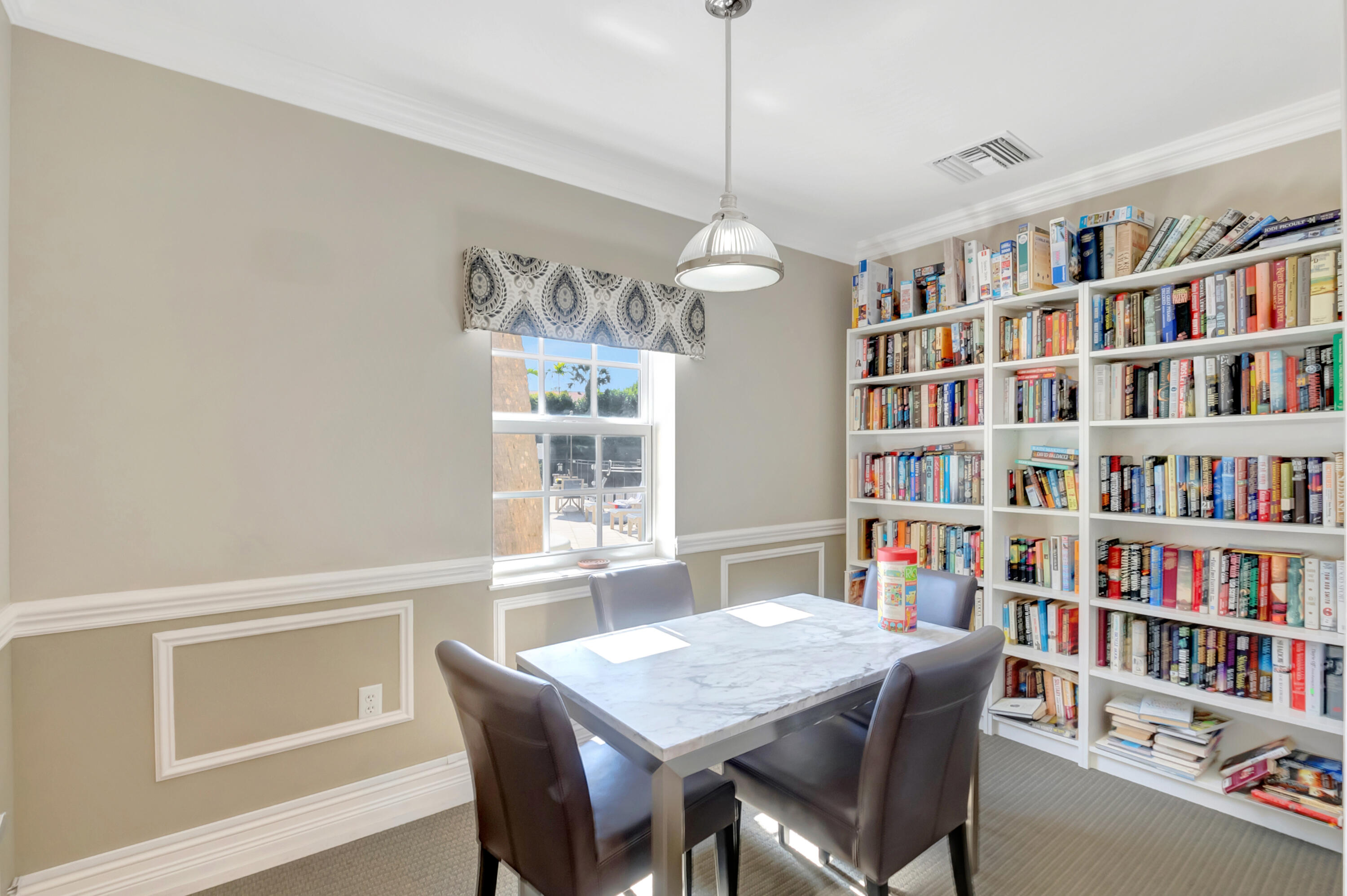 2871 North Ocean Boulevard, Unit C205 Boca Raton, FL 33431 - Photo 53 of 97 a view of a dining room with furniture a rug and a book shelf