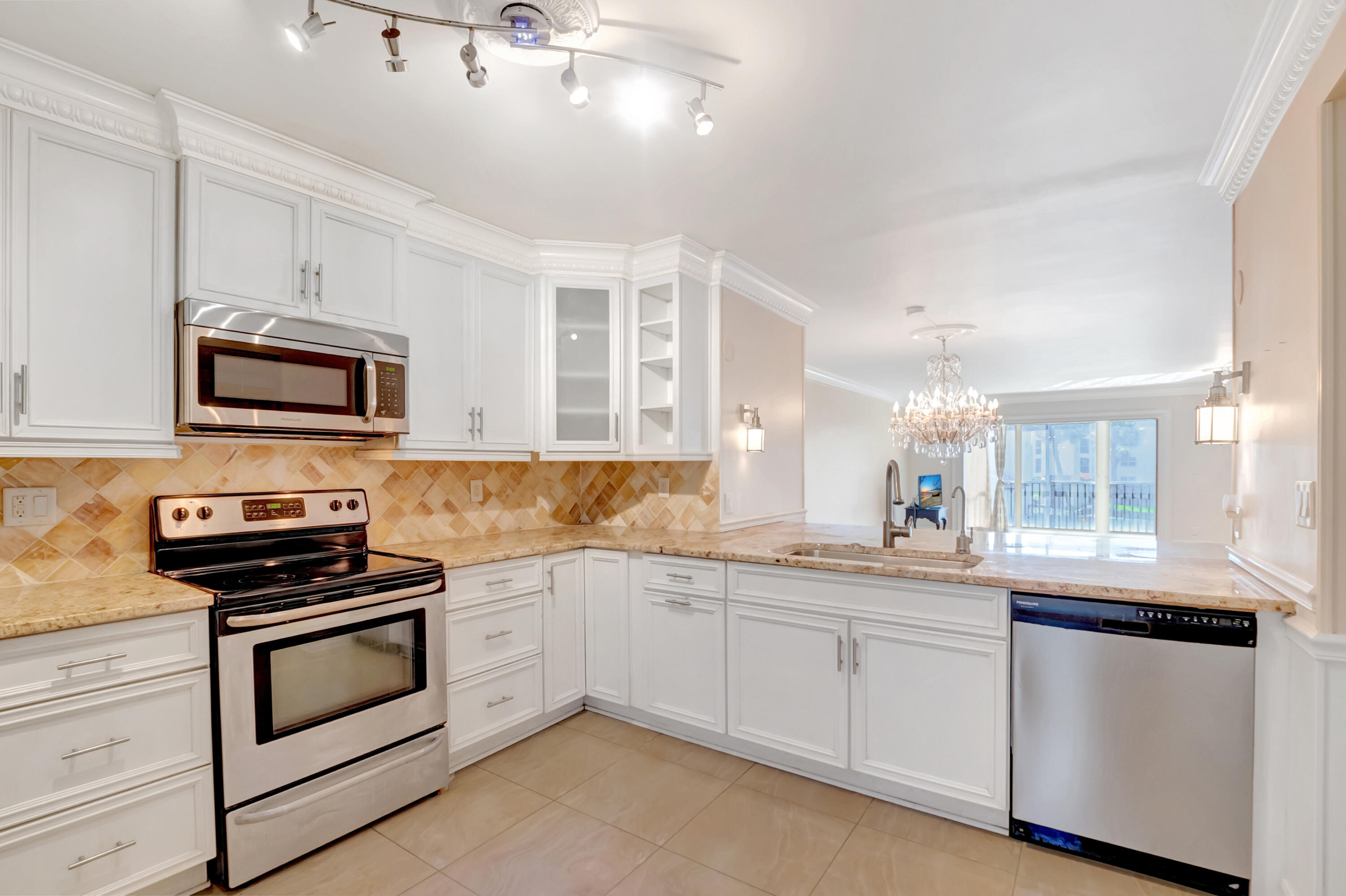 2871 North Ocean Boulevard, Unit C205 Boca Raton, FL 33431 - Photo 6 of 97 a kitchen with a sink stove and microwave