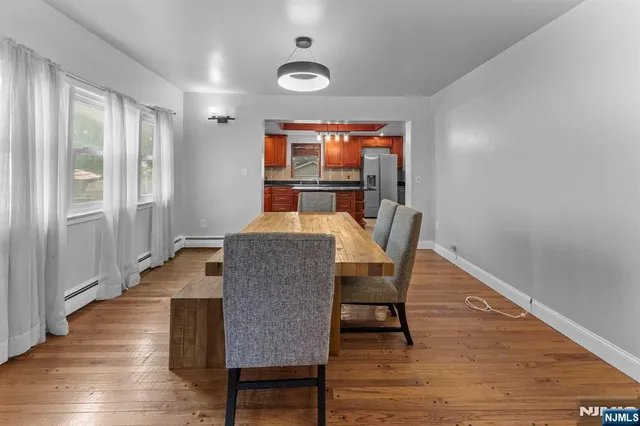 a dining room with furniture and wooden floor
