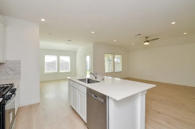 a kitchen with sink and refrigerator