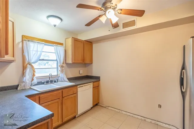 a kitchen with stainless steel appliances granite countertop a refrigerator and a stove