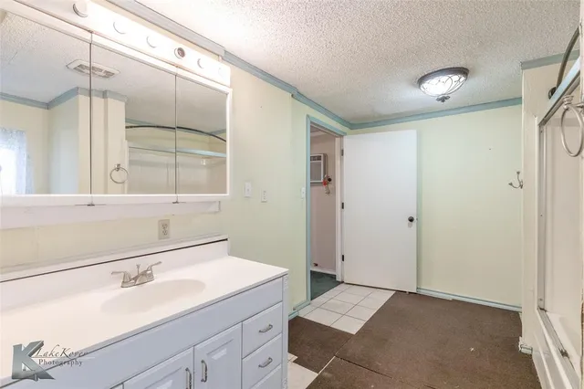 a view of a room with window and ceiling fan