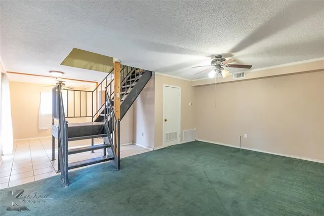 a view of an empty room with stairs