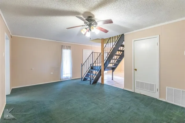 a view of an empty room with stairs