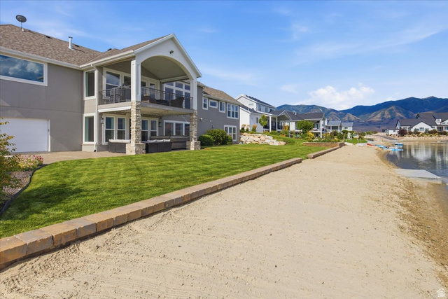 21 Pier Place Tooele, UT 84074 - Photo 99 of 112 Rear exterior featuring a two-story covered patio with stone columns and iron railings
