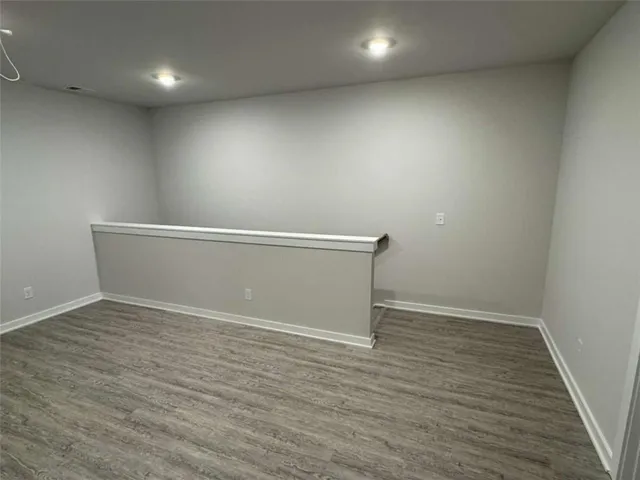 an empty room with wooden floor