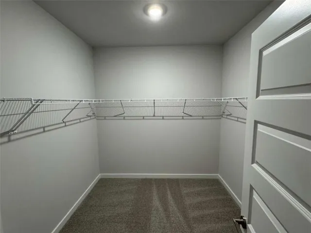a view of storage and utility room with racks on the wall